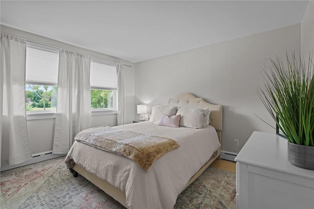 96 Roger Williams Dr, North Kingstown, RI 02852 - bedroom with baseboard heating, light wood-style floors, and baseboards