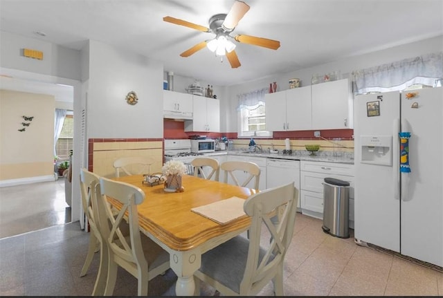 97 Detroit Ave, Providence, RI 02907 - kitchen featuring white appliances, under cabinet range hood, light countertops, and white cabinetry