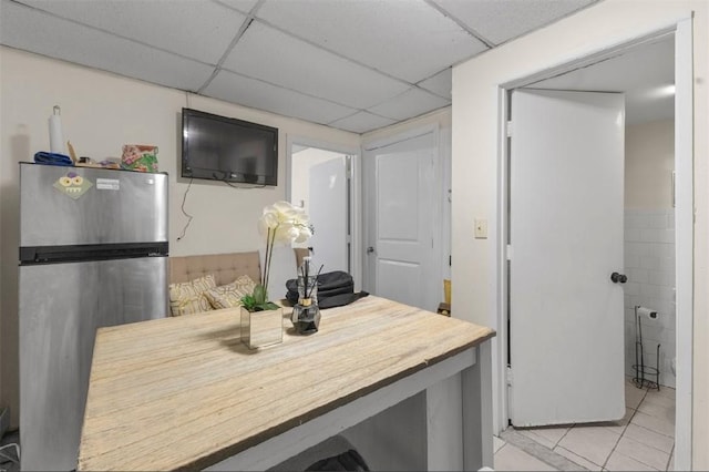 97 Detroit Ave, Providence, RI 02907 - kitchen with freestanding refrigerator, light tile patterned floors, and a drop ceiling