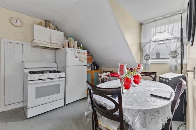 97 Detroit Ave, Providence, RI 02907 - kitchen featuring white appliances, under cabinet range hood, and lofted ceiling