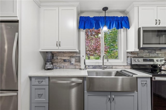 539 Allen Ave, South Kingstown, RI 02879 - kitchen featuring stainless steel appliances, a sink, decorative backsplash, gray cabinets, and white cabinetry