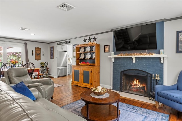 539 Allen Ave, South Kingstown, RI 02879 - living area featuring crown molding, a fireplace, hardwood / wood-style flooring, baseboards, and recessed lighting