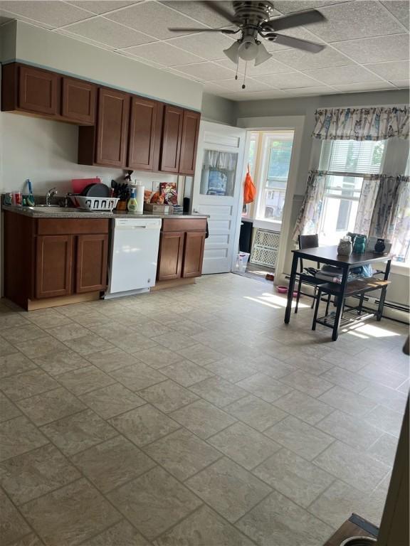 79 Dewey St, Woonsocket, RI 02895 - kitchen with dishwasher, ceiling fan, brown cabinetry, and a sink