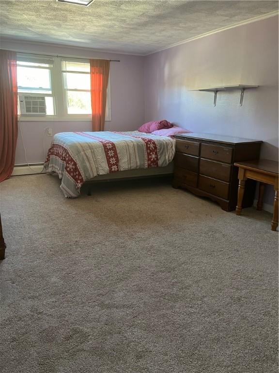 79 Dewey St, Woonsocket, RI 02895 - bedroom featuring a textured ceiling, crown molding, light carpet, cooling unit, and a baseboard heating unit