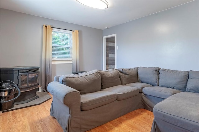 living room featuring a wood stove and light wood-type flooring