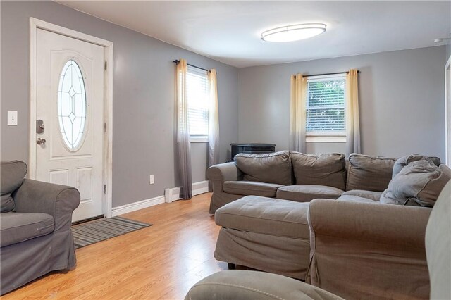 living area featuring light wood-style floors and baseboards