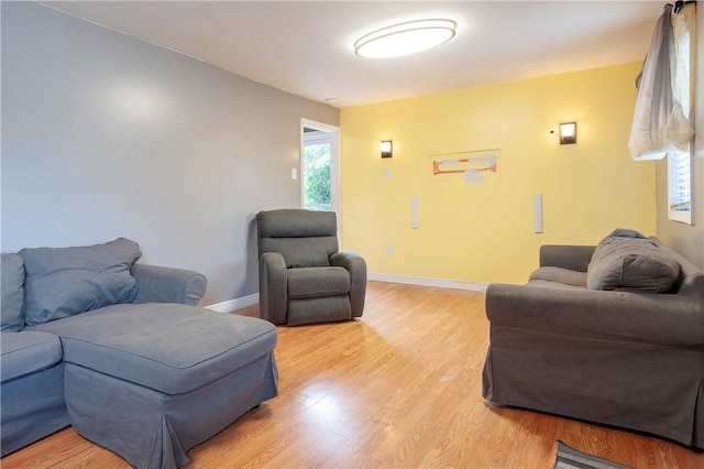 living area with light wood finished floors and baseboards