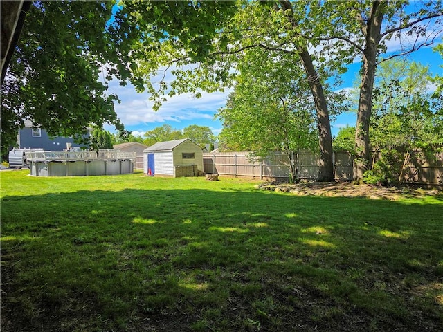 view of yard with a storage shed and an outbuilding