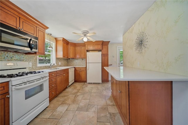 10 Meadowland Dr, North Kingstown, RI 02852 - kitchen with white appliances, tasteful backsplash, light countertops, a ceiling fan, and brown cabinetry