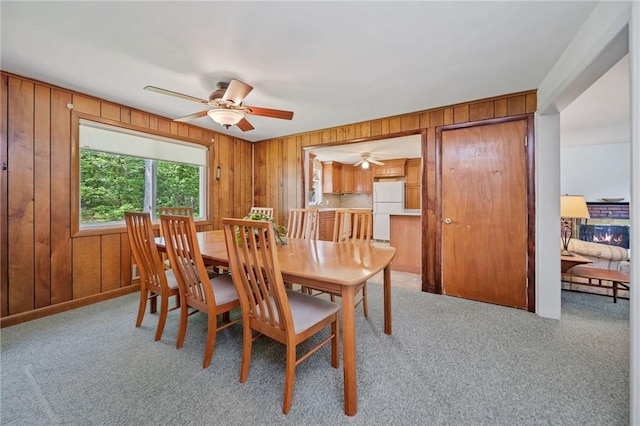 10 Meadowland Dr, North Kingstown, RI 02852 - dining room featuring ceiling fan, wood walls, and light carpet