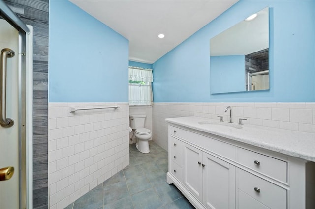 10 Meadowland Dr, North Kingstown, RI 02852 - full bath with tile walls, tile patterned flooring, wainscoting, vanity, and toilet