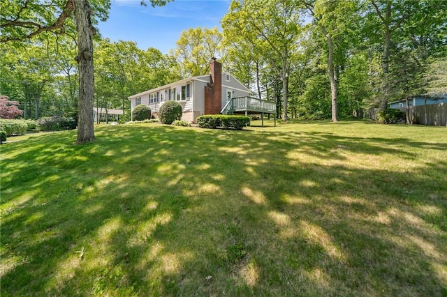 10 Meadowland Dr, North Kingstown, RI 02852 - view of green lawn with a wooden deck and view of scattered trees