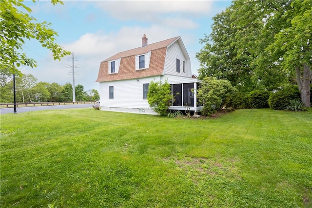 222 Second St, East Providence, RI 02865 - rear view of house featuring a gambrel roof, a sunroom, a chimney, and roof with shingles