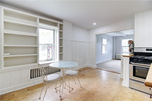 222 Second St, East Providence, RI 02865 - dining space featuring radiator heating unit, a decorative wall, and built in features