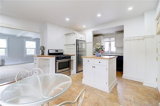 222 Second St, East Providence, RI 02865 - kitchen featuring appliances with stainless steel finishes, a center island, plenty of natural light, recessed lighting, and white cabinetry