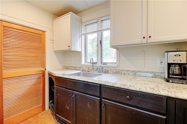 222 Second St, East Providence, RI 02865 - kitchen with a sink, white cabinetry, and dark brown cabinetry