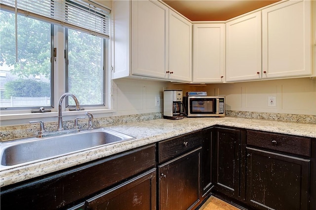 222 Second St, East Providence, RI 02865 - kitchen with a sink, white cabinets, stainless steel microwave, and plenty of natural light