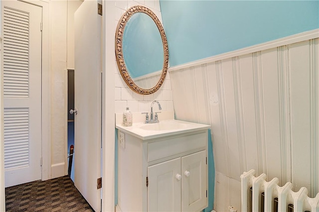 222 Second St, East Providence, RI 02865 - bathroom featuring radiator, vanity, and decorative backsplash