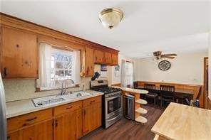33 Merle St, Warwick, RI 02889 - kitchen featuring stainless steel range with gas stovetop, light countertops, brown cabinets, and plenty of natural light