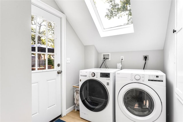 7 Massasoit Ave, Pawtucket, RI 02861 - washroom with washing machine and clothes dryer, a skylight, plenty of natural light, and light wood-style floors