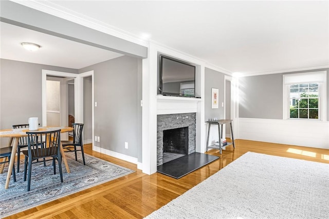 7 Massasoit Ave, Pawtucket, RI 02861 - living area with wood finished floors, a fireplace with raised hearth, baseboards, and ornamental molding