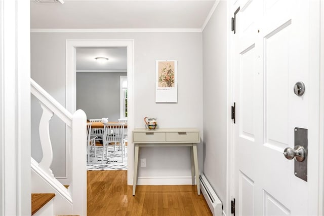 7 Massasoit Ave, Pawtucket, RI 02861 - entryway with baseboard heating, wood finished floors, stairs, baseboards, and ornamental molding