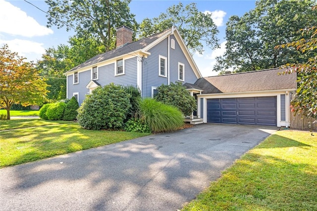 7 Massasoit Ave, Pawtucket, RI 02861 - view of front of home featuring a chimney, a front lawn, driveway, and a garage