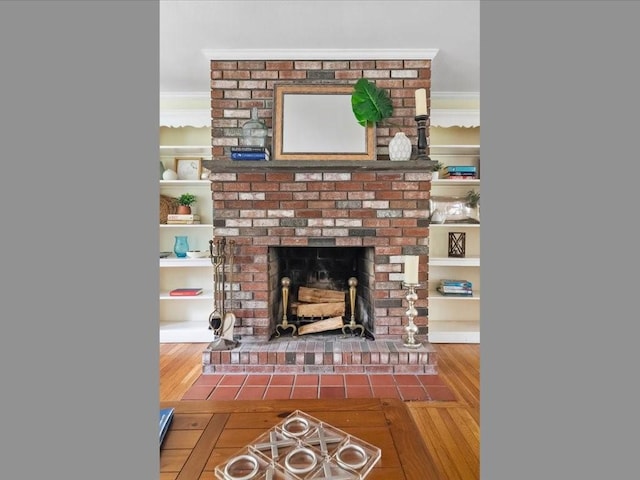 detailed view of wood finished floors, a fireplace, and crown molding