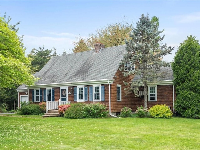view of front facade with roof with shingles, a front lawn, a chimney, and a garage