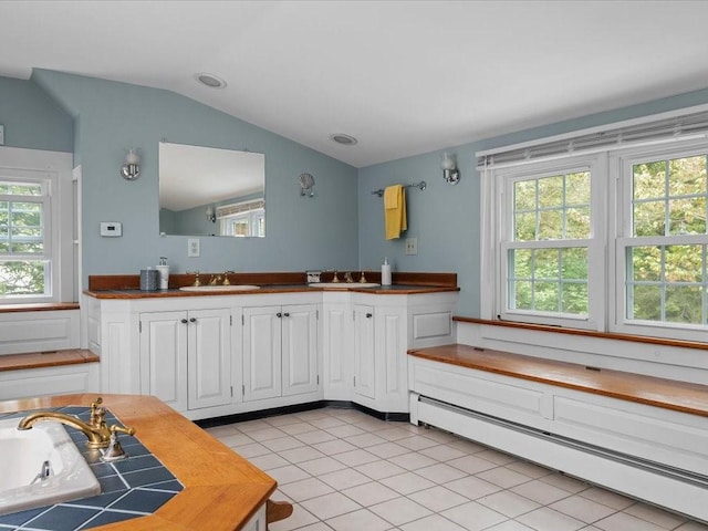 full bath with a baseboard heating unit, lofted ceiling, tile patterned flooring, and vanity