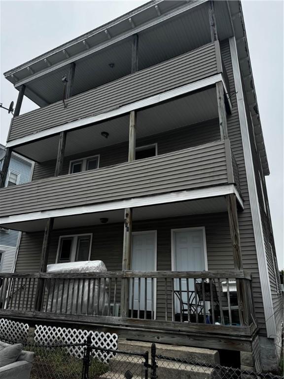 342 Paradis Ave, Woonsocket, RI 02895 - back of house with fence, a porch, and a balcony