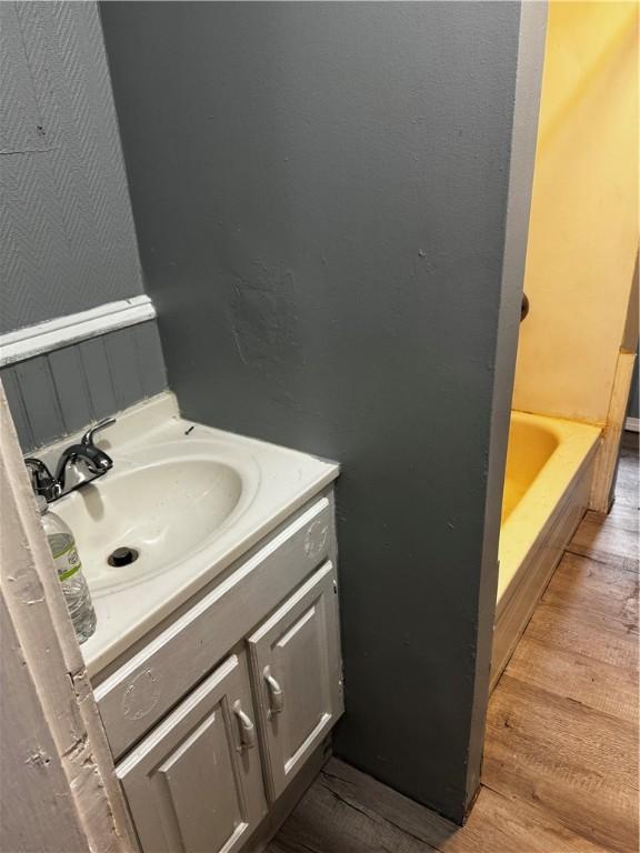 342 Paradis Ave, Woonsocket, RI 02895 - bathroom with wood finished floors, vanity, and a tub