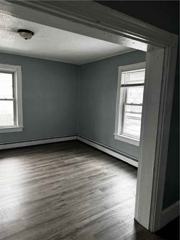 342 Paradis Ave, Woonsocket, RI 02895 - spare room with dark wood-style floors, a textured ceiling, and baseboards