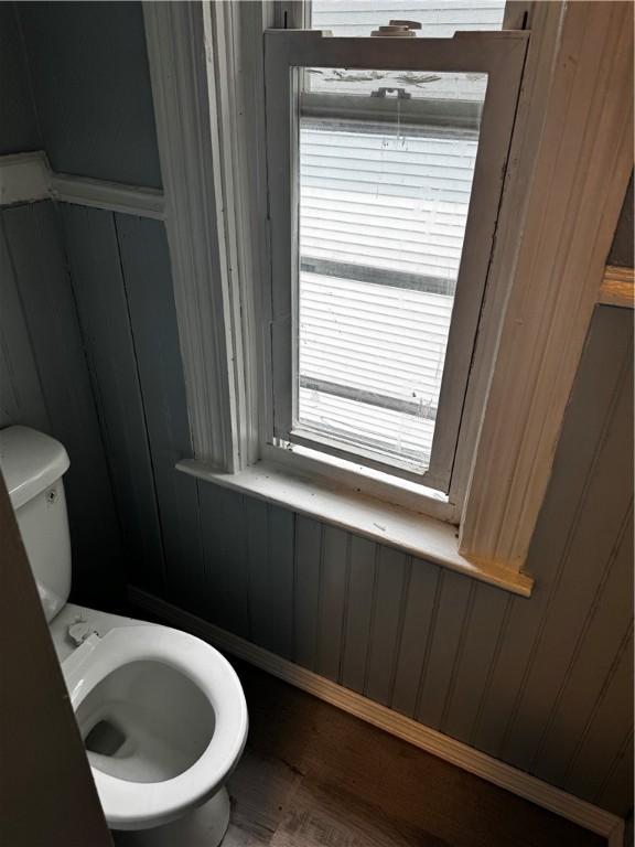 342 Paradis Ave, Woonsocket, RI 02895 - bathroom with wood finished floors, toilet, and wood walls