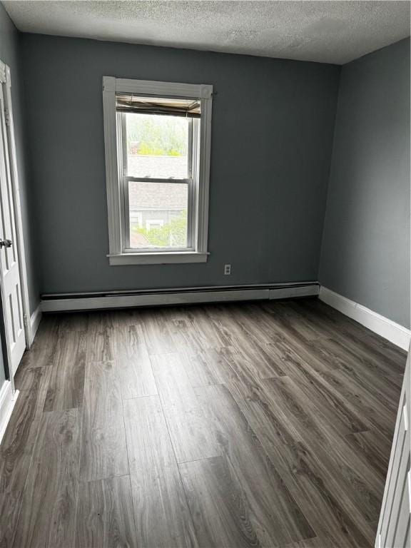 342 Paradis Ave, Woonsocket, RI 02895 - unfurnished room featuring a baseboard radiator, dark wood finished floors, a textured ceiling, and baseboards