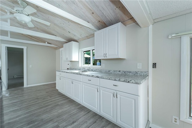 46 E Andrew Comstock Rd, Warwick, RI 02886 - kitchen with a baseboard radiator, white cabinetry, light wood-style floors, a ceiling fan, and baseboards
