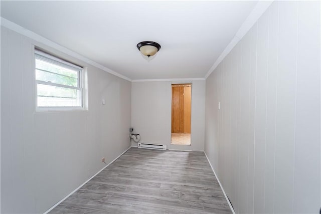46 E Andrew Comstock Rd, Warwick, RI 02886 - spare room with a baseboard radiator, light wood-style floors, and crown molding