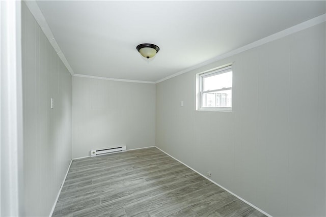 46 E Andrew Comstock Rd, Warwick, RI 02886 - empty room featuring a baseboard radiator, wood finished floors, and crown molding
