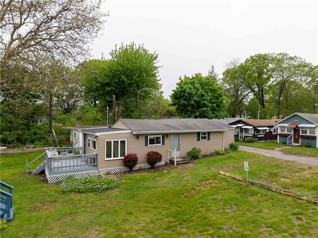 46 E Andrew Comstock Rd, Warwick, RI 02886 - view of front facade with a wooden deck, a front lawn, and view of scattered trees