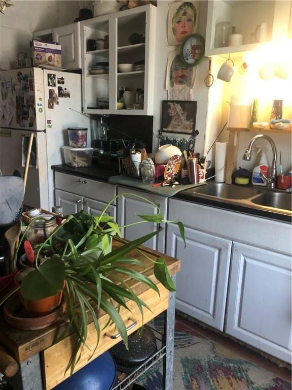 149 Peace St, Providence, RI 05290 - kitchen with a sink, freestanding refrigerator, and white cabinetry