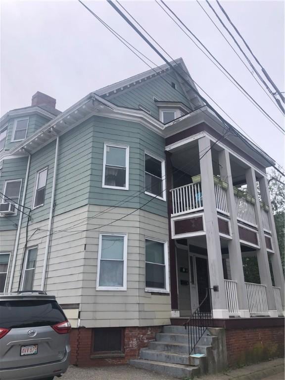 10 Bellevue Ave, Providence, RI 02907 - view of side of home featuring a balcony and a chimney