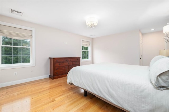 1351 Pippin Orchard Rd, Cranston, RI 02921 - bedroom with light wood-type flooring, baseboards, and a chandelier