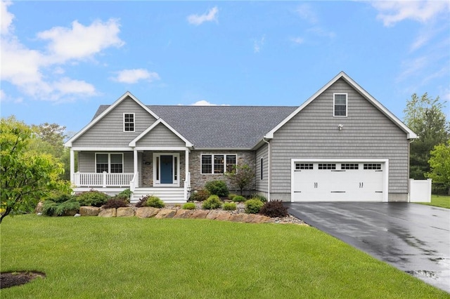 1351 Pippin Orchard Rd, Cranston, RI 02921 - view of front of property featuring asphalt driveway, a porch, a front yard, stone siding, and a shingled roof