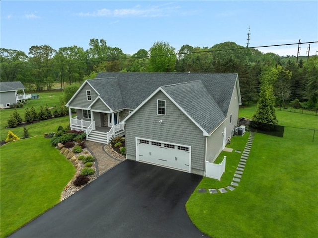 1351 Pippin Orchard Rd, Cranston, RI 02921 - view of front of home with covered porch, asphalt driveway, cooling unit, and a shingled roof