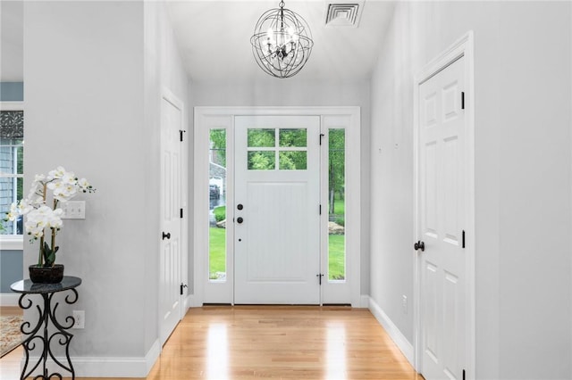 1351 Pippin Orchard Rd, Cranston, RI 02921 - entryway with light wood-style flooring, a chandelier, and baseboards