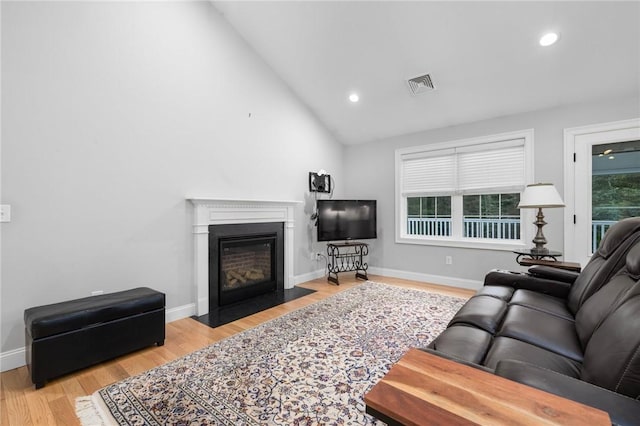 1351 Pippin Orchard Rd, Cranston, RI 02921 - living area featuring a fireplace with flush hearth, wood finished floors, baseboards, recessed lighting, and high vaulted ceiling