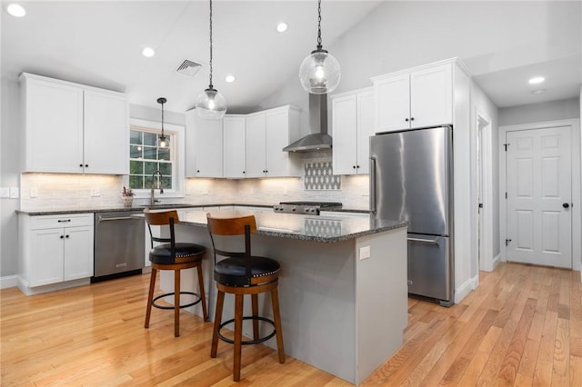 1351 Pippin Orchard Rd, Cranston, RI 02921 - kitchen with appliances with stainless steel finishes, a sink, a center island, white cabinetry, and a kitchen bar