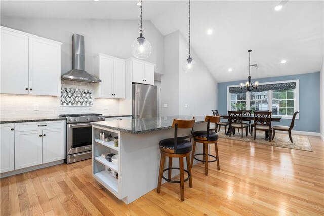 1351 Pippin Orchard Rd, Cranston, RI 02921 - kitchen featuring stainless steel appliances, wall chimney range hood, high vaulted ceiling, a kitchen island, and open shelves