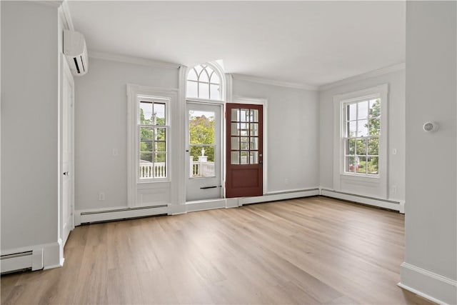 217 Hope St Unit 3, Bristol, RI 02809 - entrance foyer featuring a baseboard radiator, a wall mounted AC, wood finished floors, crown molding, and healthy amount of natural light
