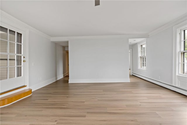 217 Hope St Unit 3, Bristol, RI 02809 - spare room with ornamental molding, light wood-style floors, baseboard heating, and baseboards